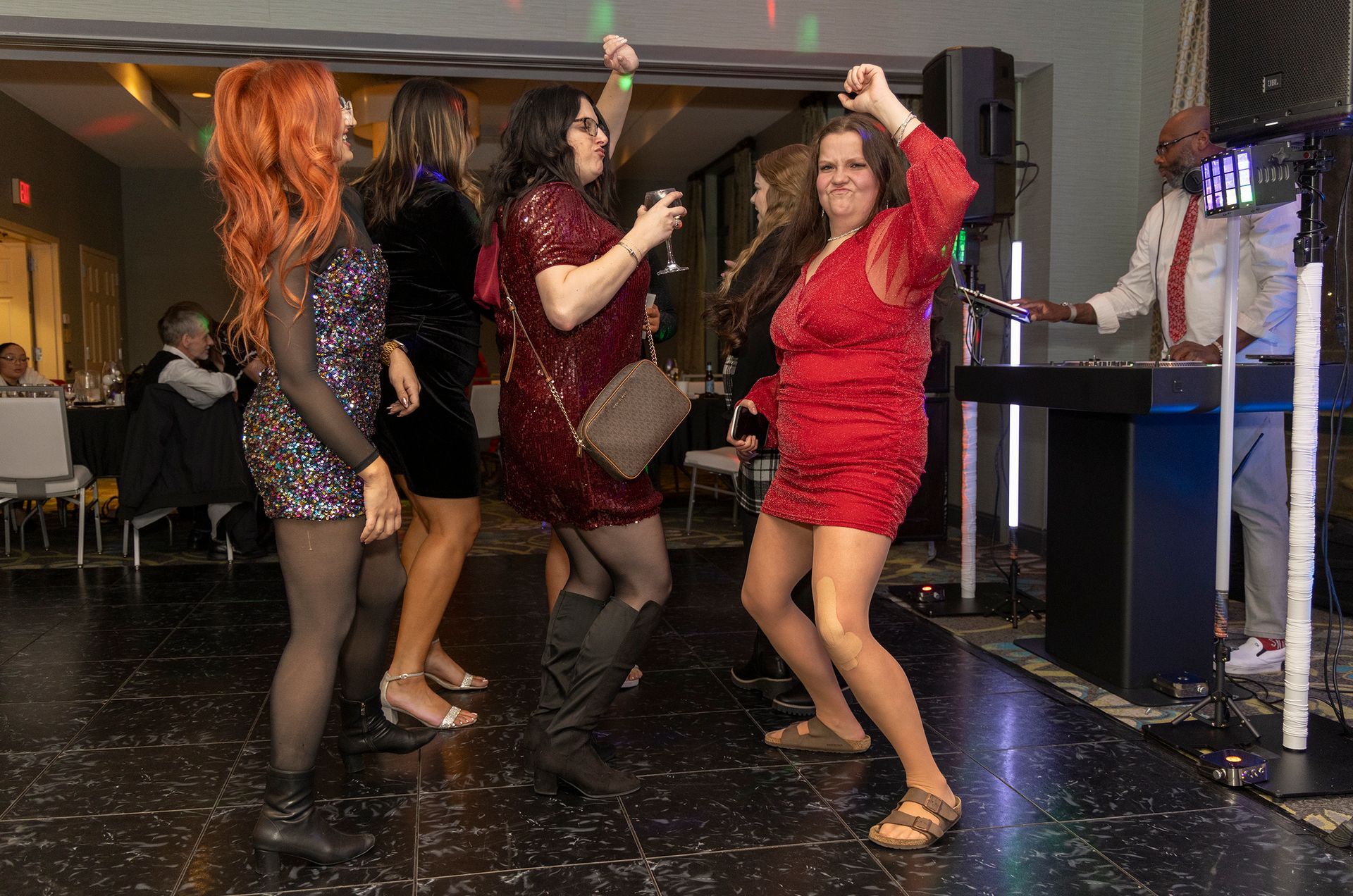 A group of women are dancing on a dance floor at a party.