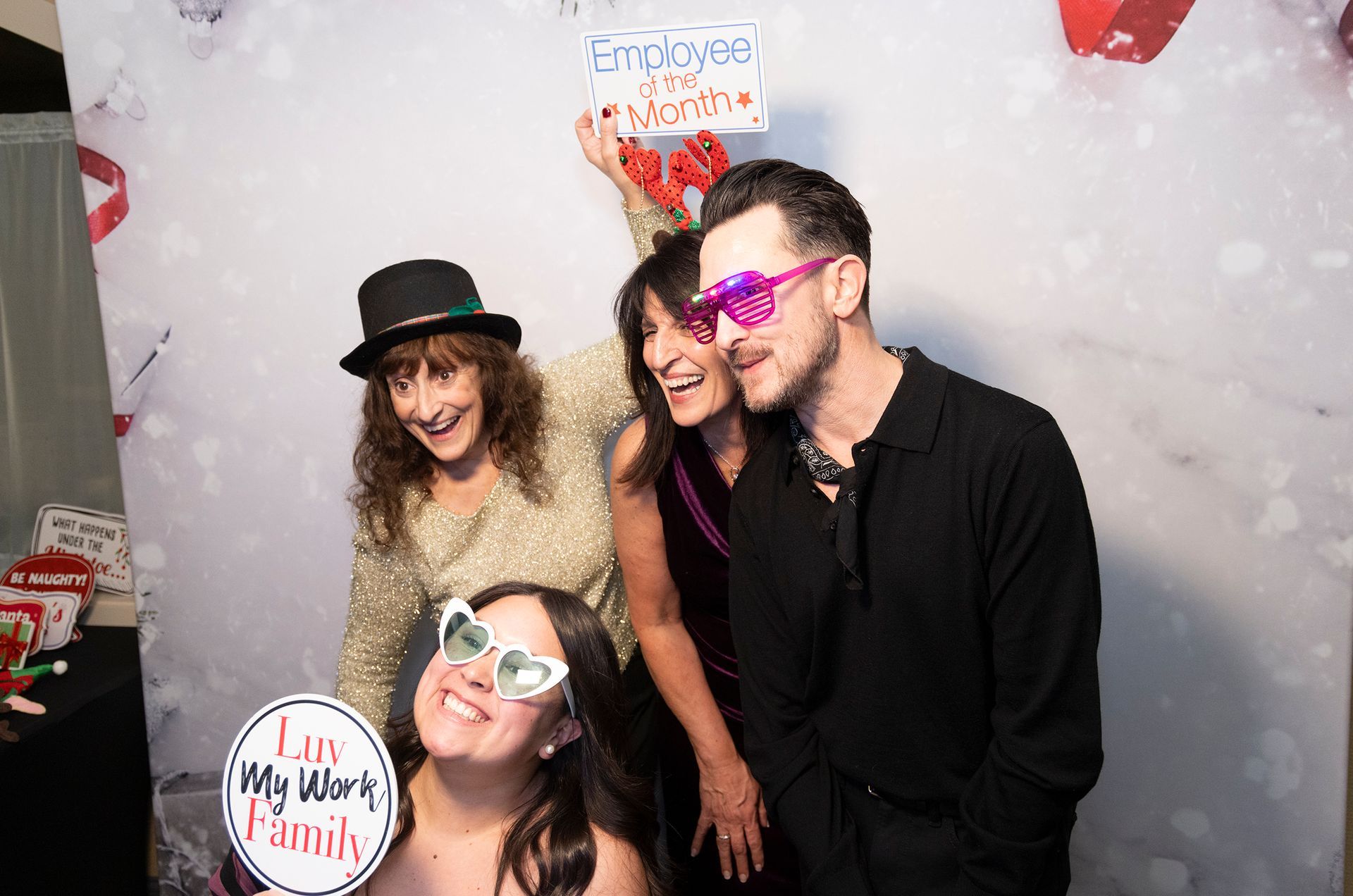 A group of people are posing for a picture in a photo booth.