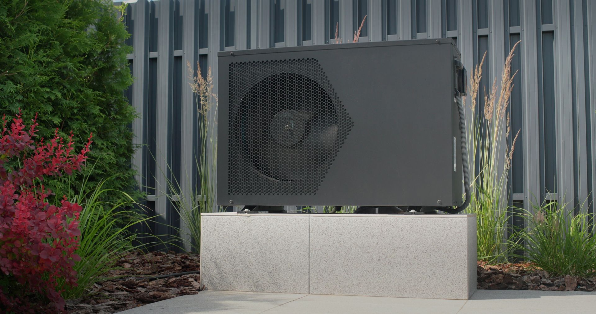 Heat Pump Unit, Dark Gray, Mounted on a Stone Base — Clearwater Pools Hallidays Point in Gloucester, NSW