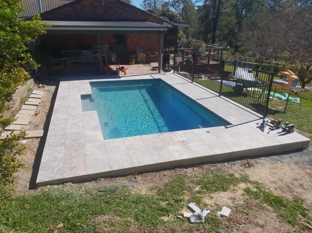 A Rectangular Pool With Light Gray Tile Surround, Set in a Backyard — Clearwater Pools Hallidays Point in Gloucester, NSW