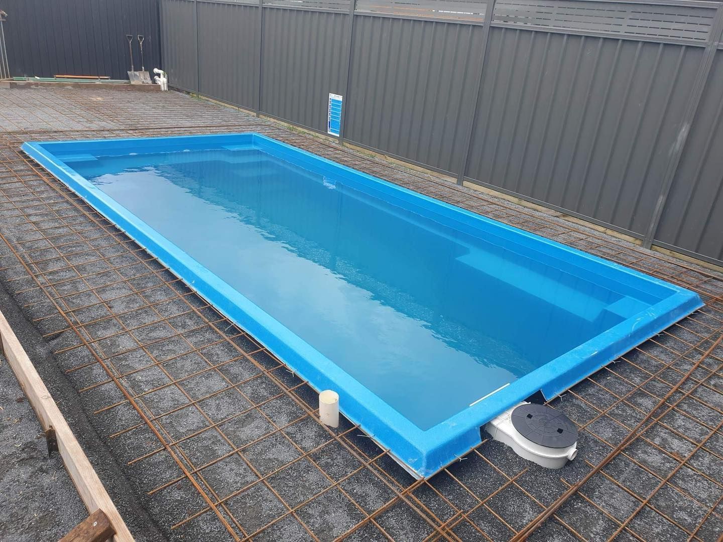 Blue Rectangular Swimming Pool in a Gravel-covered Area — Clearwater Pools Hallidays Point in Pacific Palms, NSW