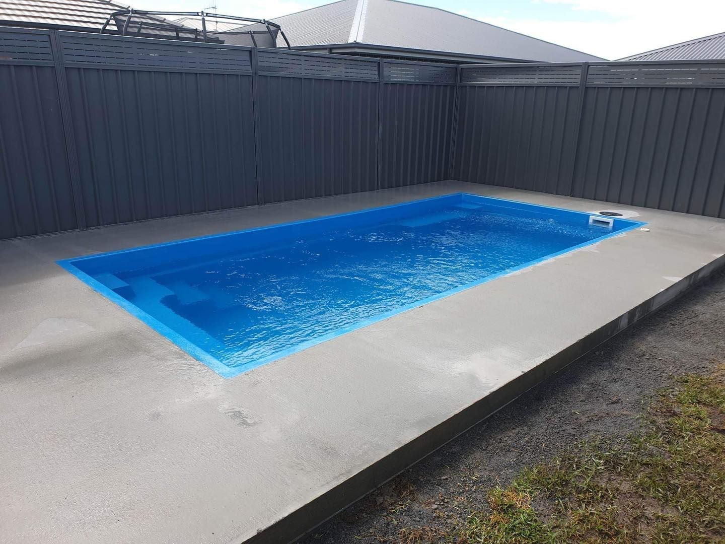Rectangular Blue Swimming Pool Surrounded by Gray Concrete — Clearwater Pools Hallidays Point in Pacific Palms, NSW