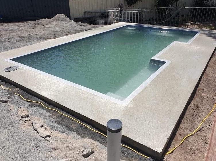 Rectangular Swimming Pool With Light Green Water and Concrete Surround — Clearwater Pools Hallidays Point in Taree, NSW