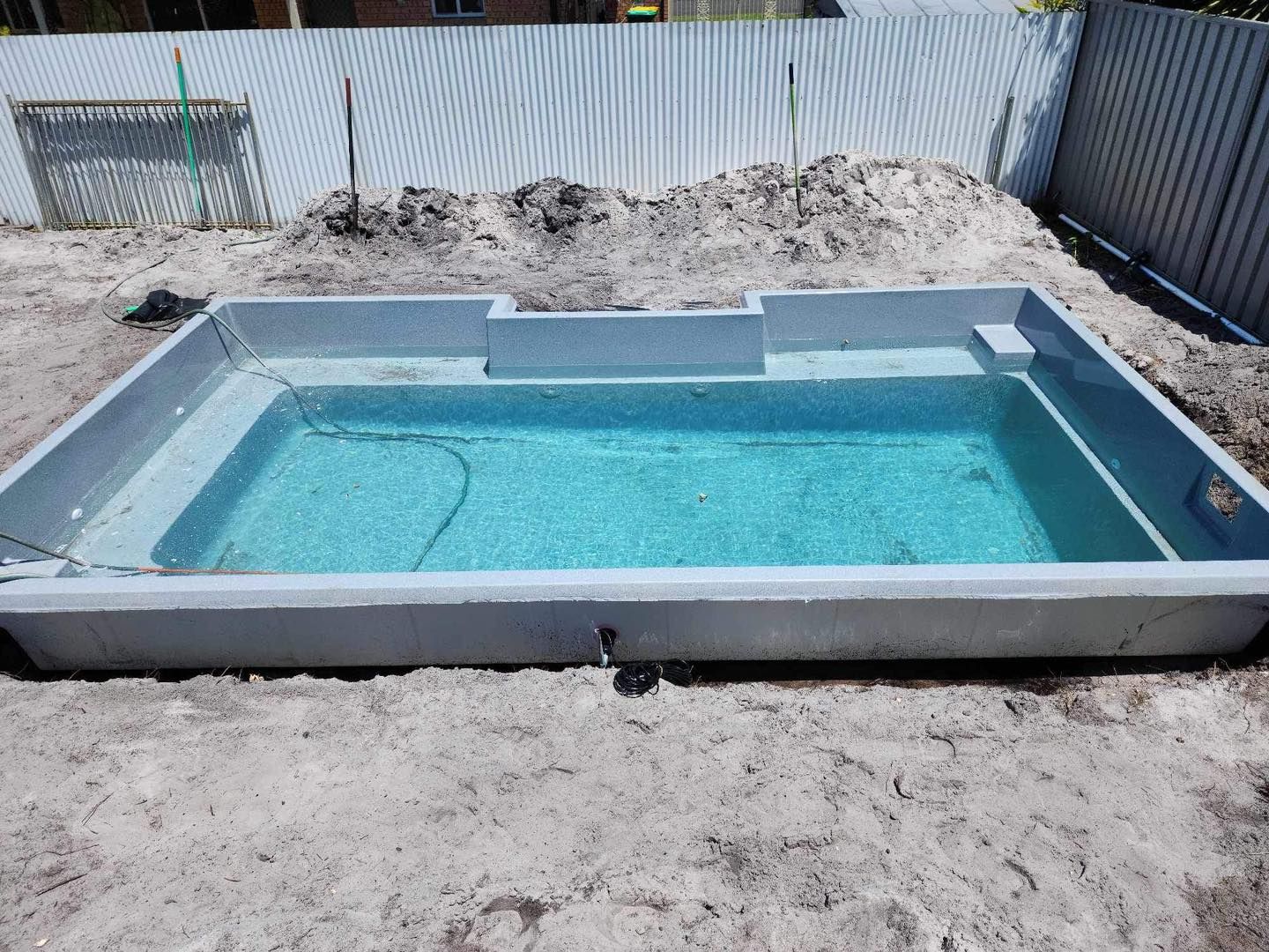 Rectangular, Light-blue Swimming Pool Surrounded by Gray Concrete — Clearwater Pools Hallidays Point in Gloucester, NSW