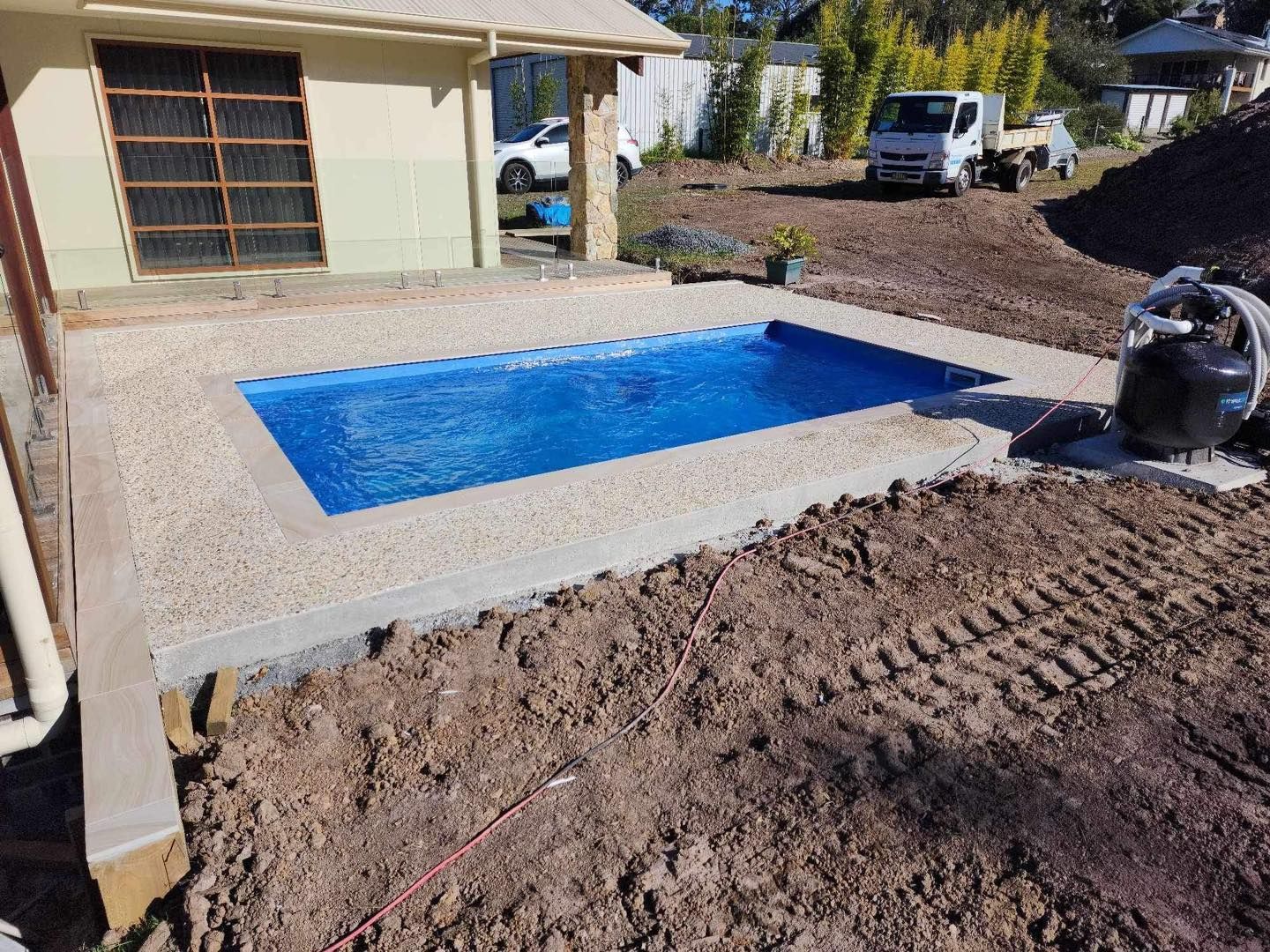 Rectangular Blue Pool With Light Brown Concrete Surround — Clearwater Pools Hallidays Point in Bulahdelah, NSW