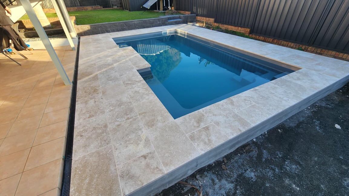 Rectangular Pool With Light Stone Coping in a Backyard Setting — Clearwater Pools Hallidays Point in Bulahdelah, NSW