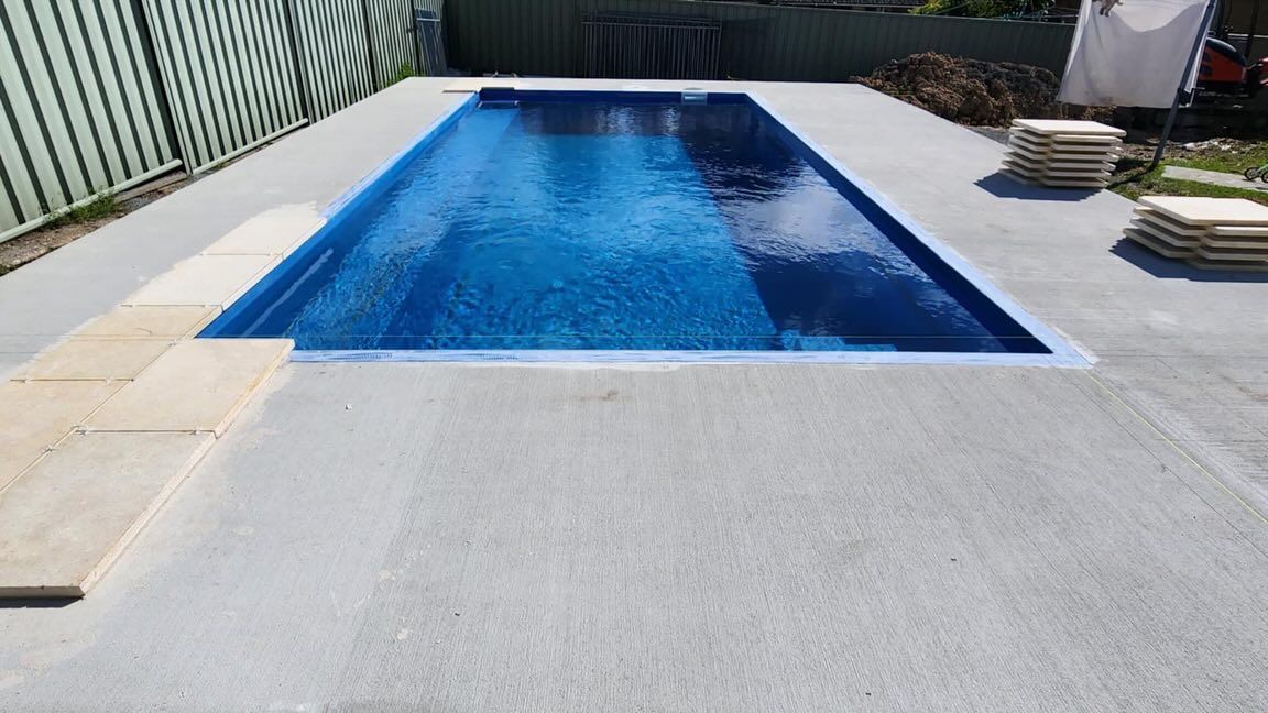 Rectangular Blue Swimming Pool Surrounded by Gray Concrete — Clearwater Pools Hallidays Point in Old Bar, NSW