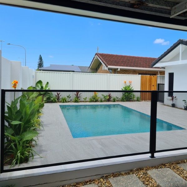 A Rectangular Swimming Pool Surrounded by A Black Mesh Fence — Clearwater Pools Hallidays Point in Hallidays Point, NSW