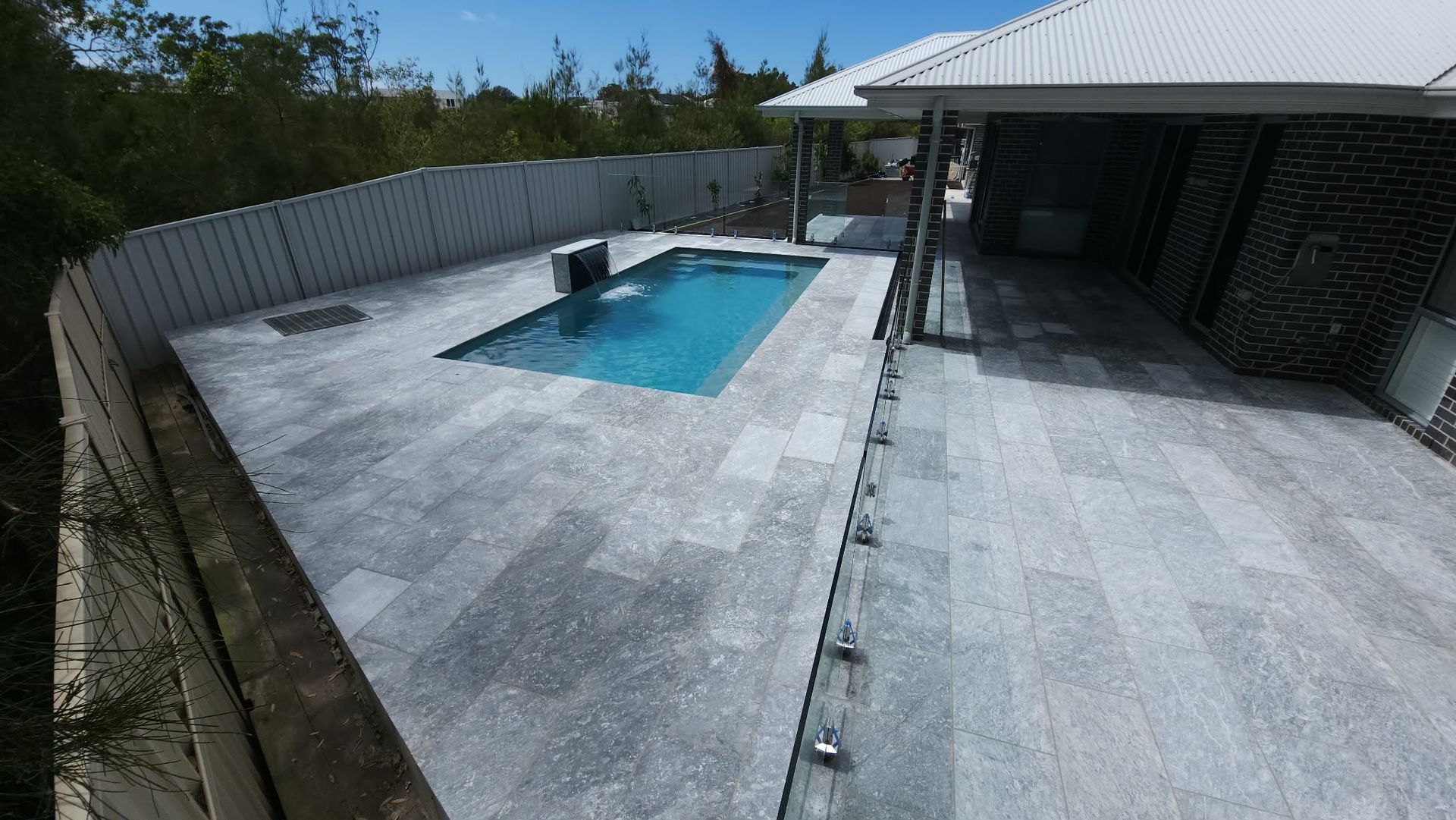 Brick Patio With Covered Walkway, Leading Towards a Pool — Clearwater Pools Hallidays Point in Hallidays Point, NSW