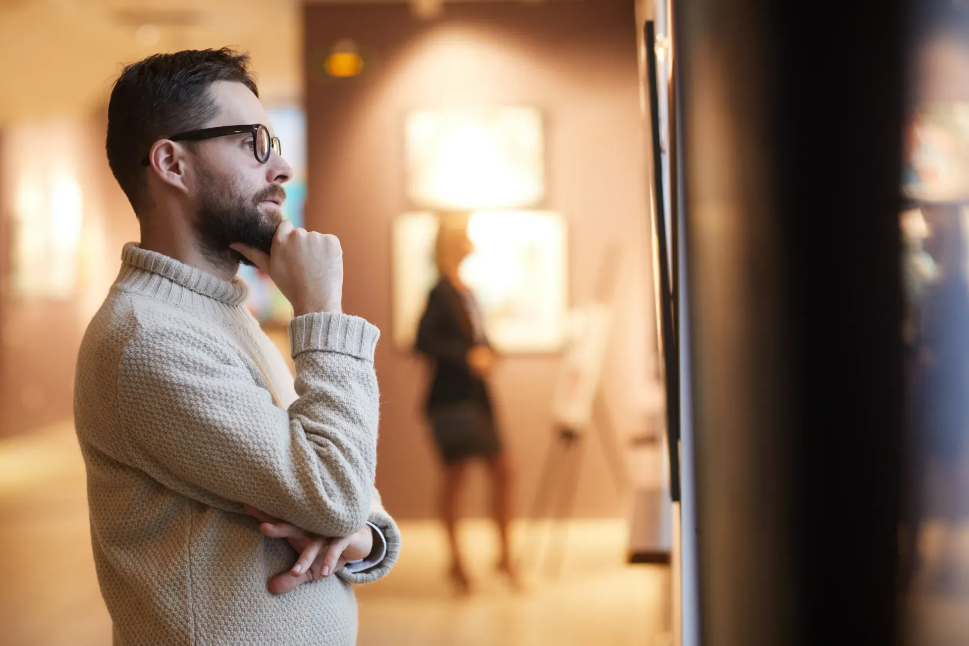 a man is looking at a painting in a museum