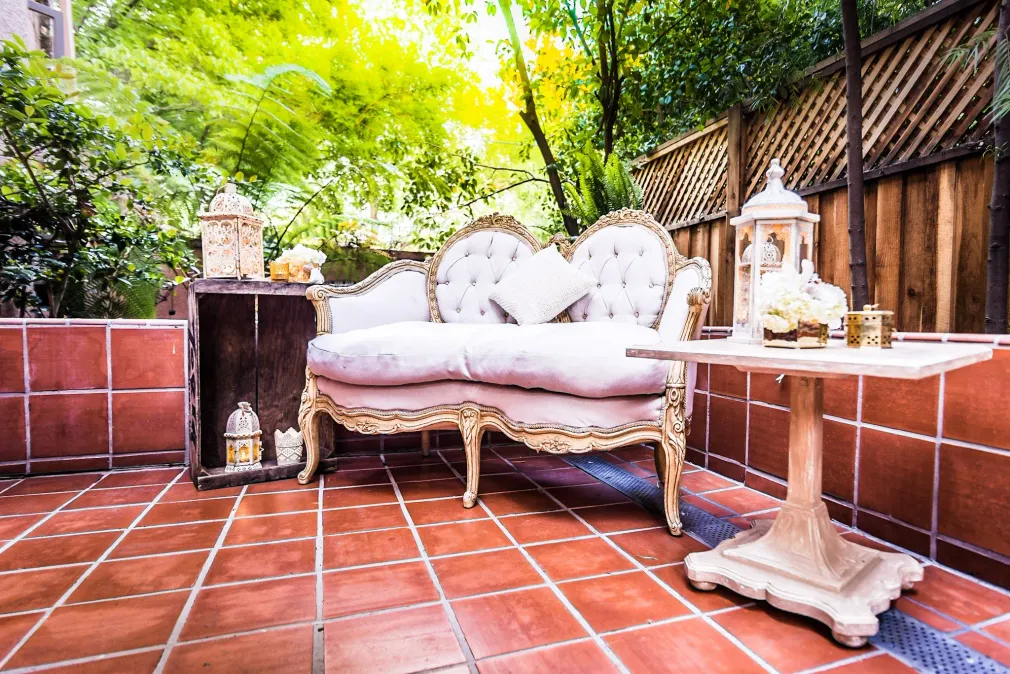 There is a couch and a table on the patio.