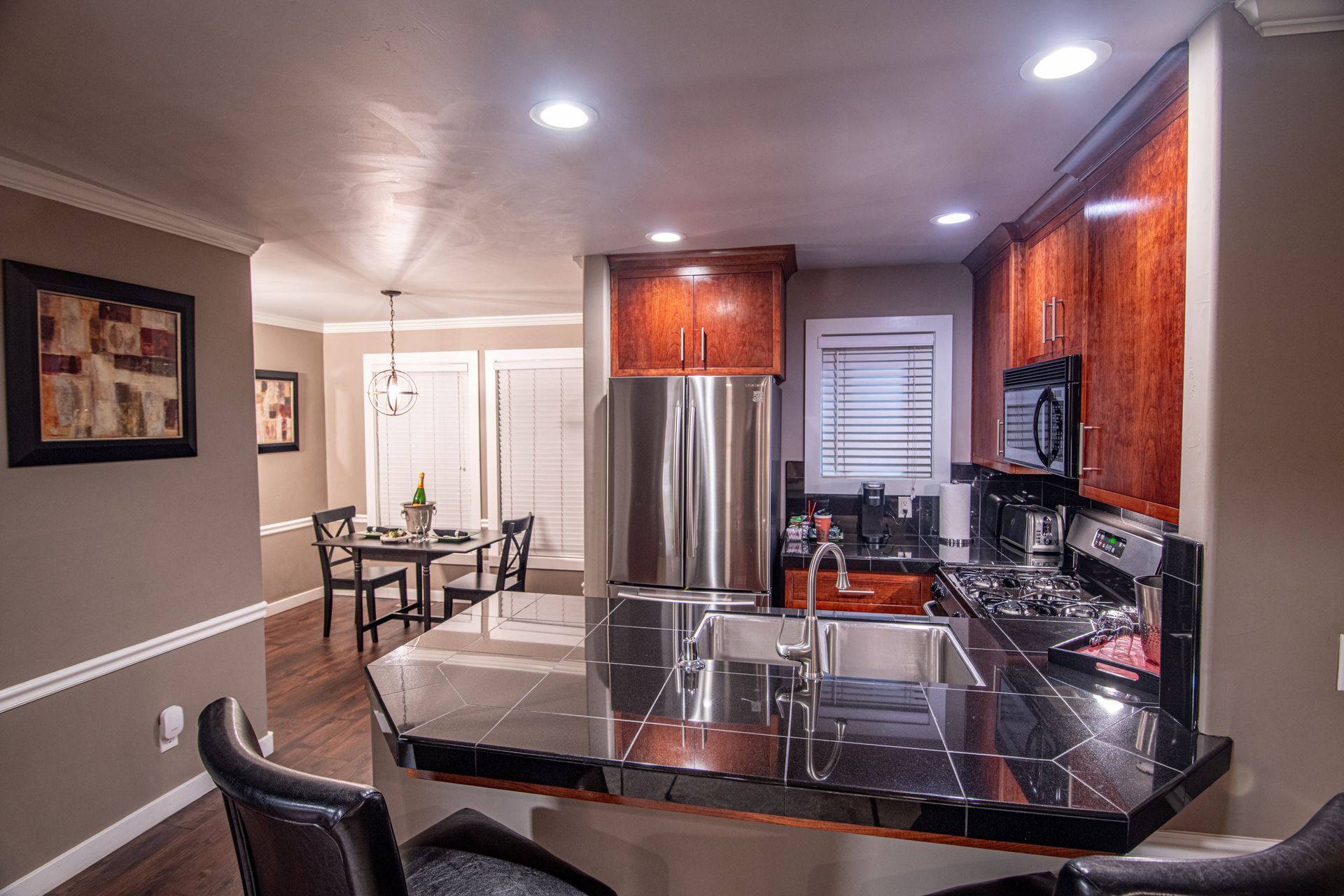A kitchen with stainless steel appliances and a granite counter top.