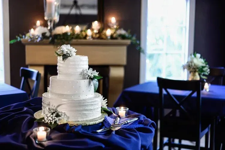 A wedding cake is sitting on a table with candles.