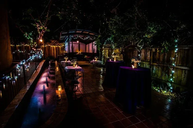 A patio with tables and chairs set up for a party at night.