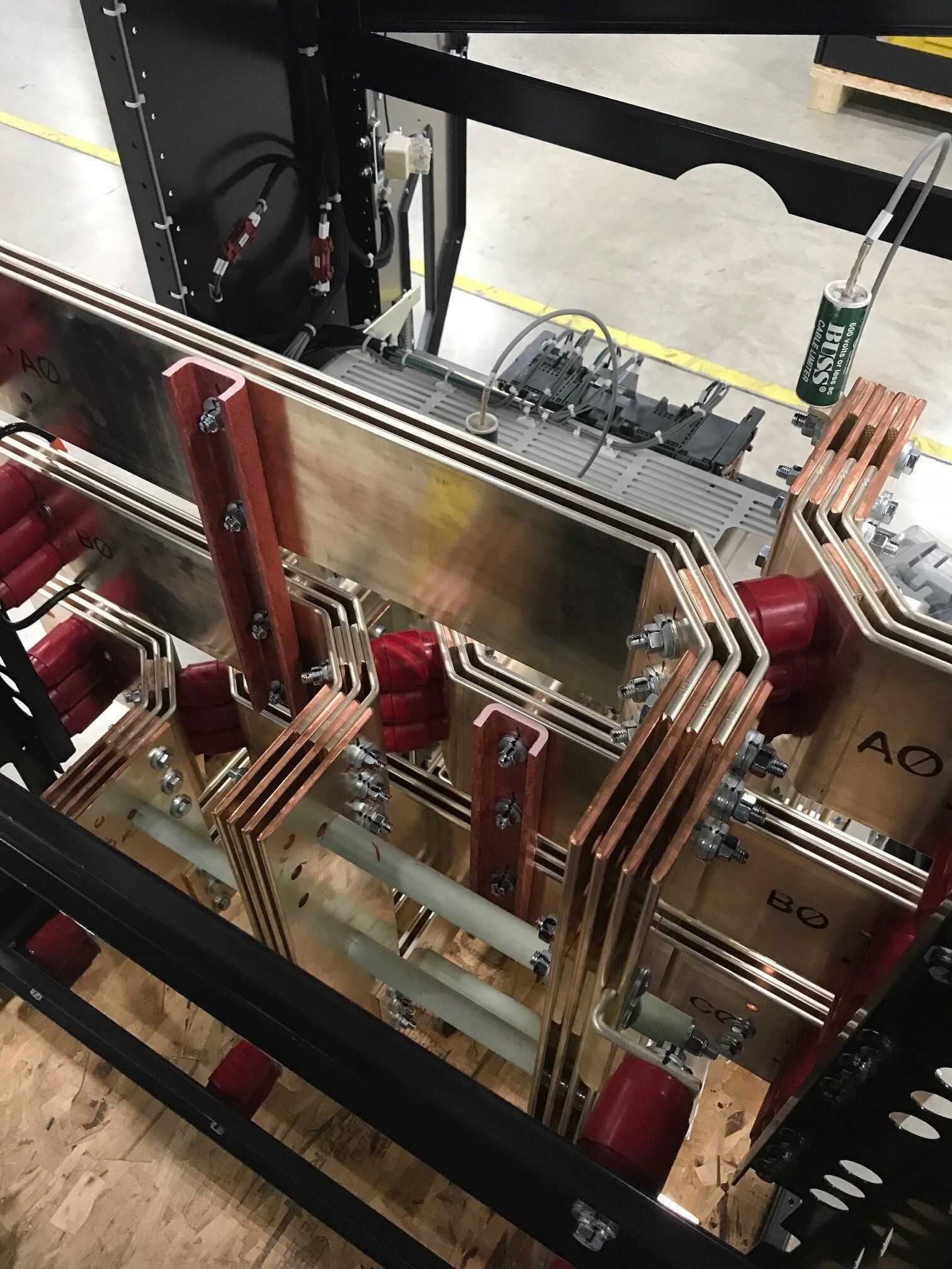 A bunch of metal pipes are connected to each other in a warehouse.