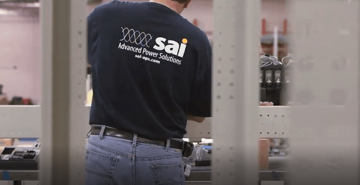 A man wearing a blue shirt with the word sai on it