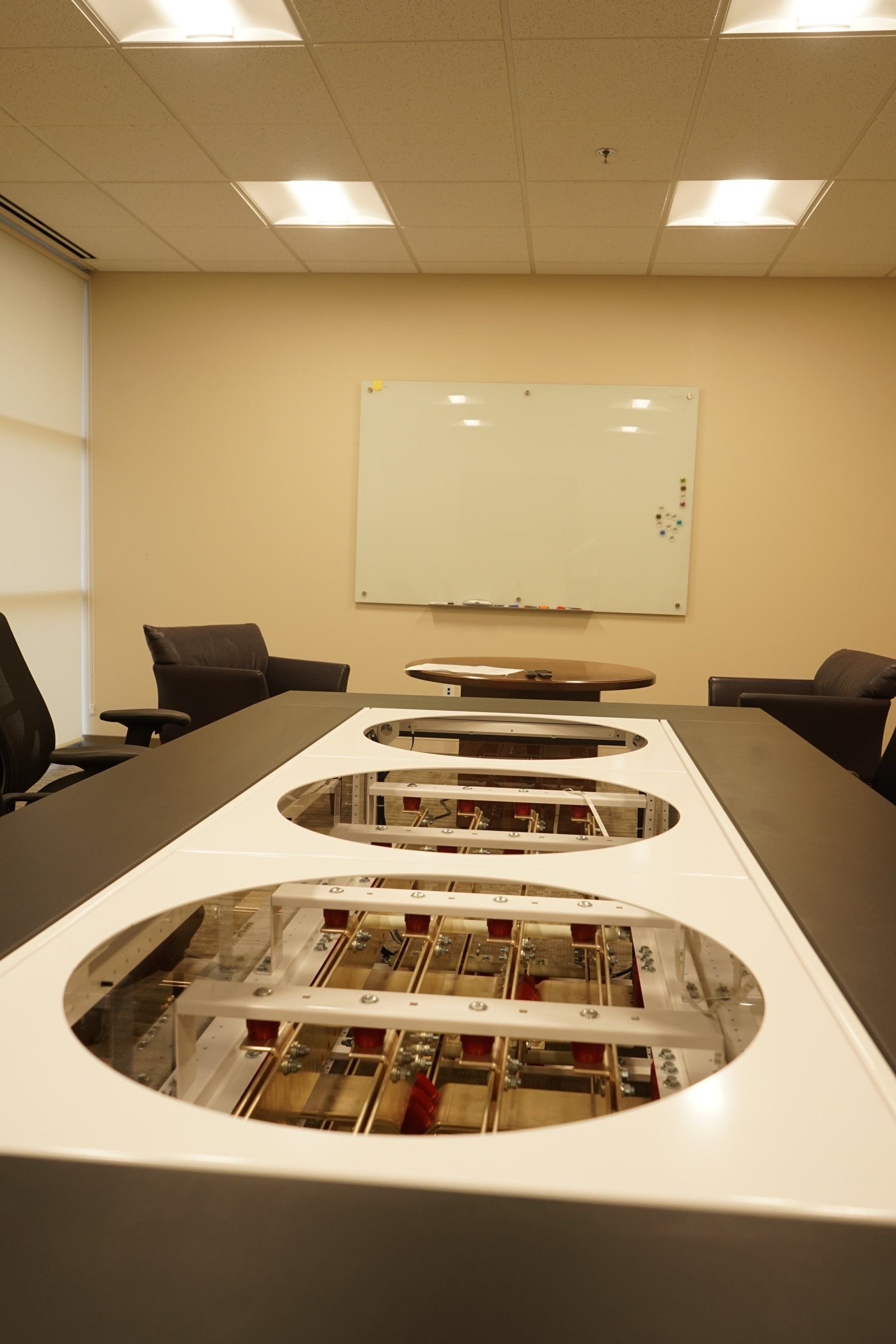 A conference room with a long table and a white board