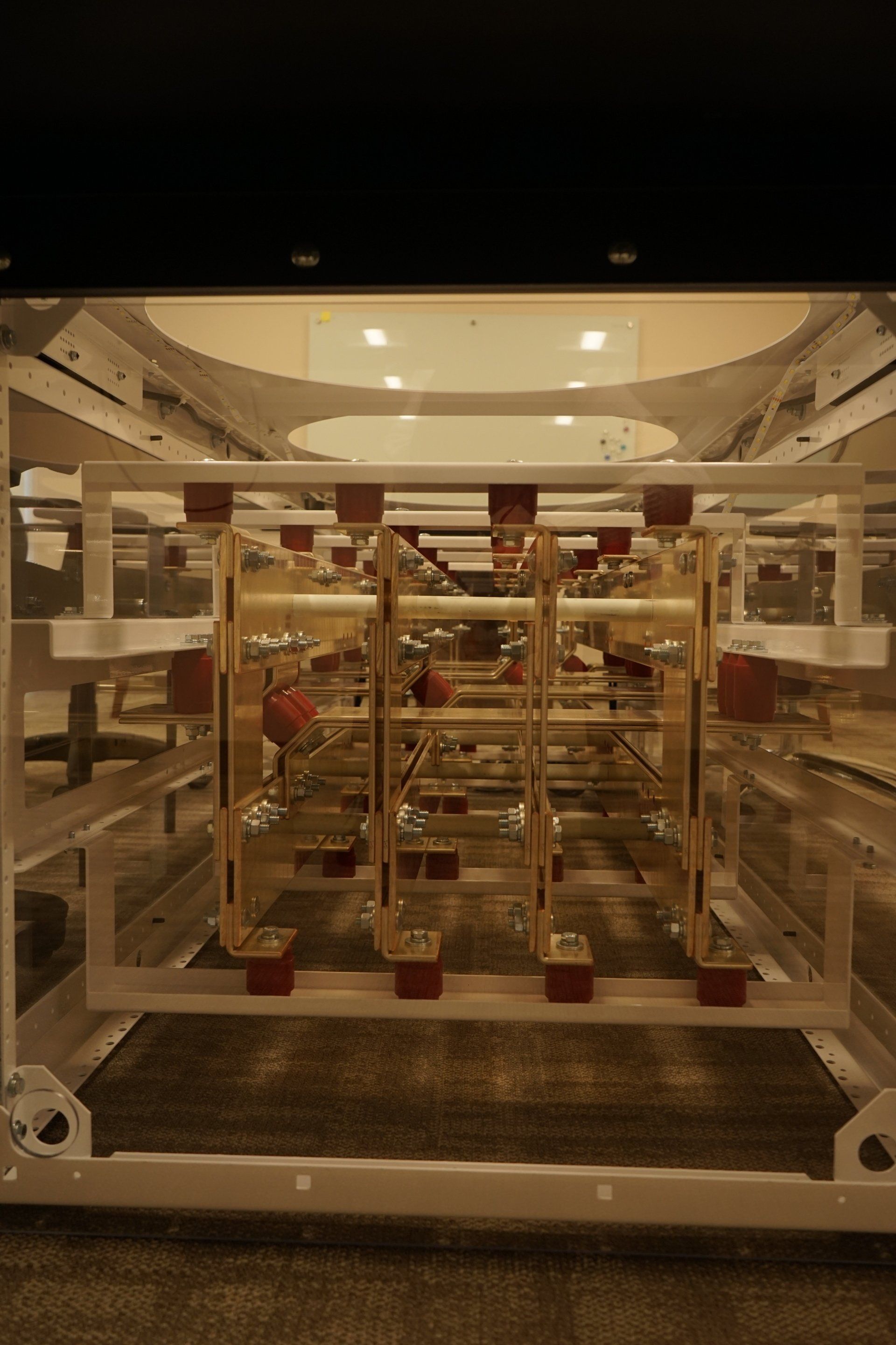 A large metal structure is sitting on top of a concrete floor in a room.