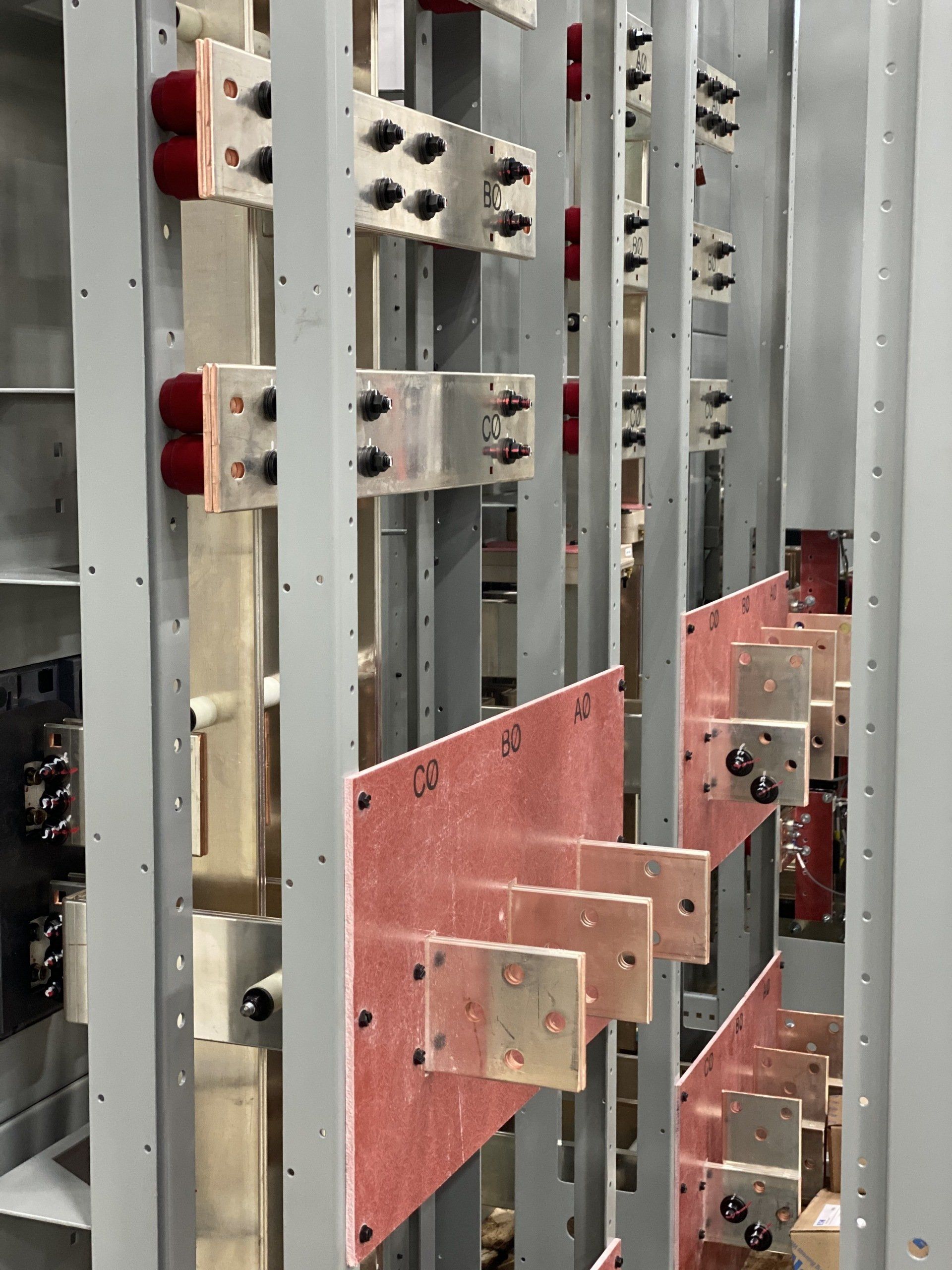 A row of electrical boards are lined up in a room.