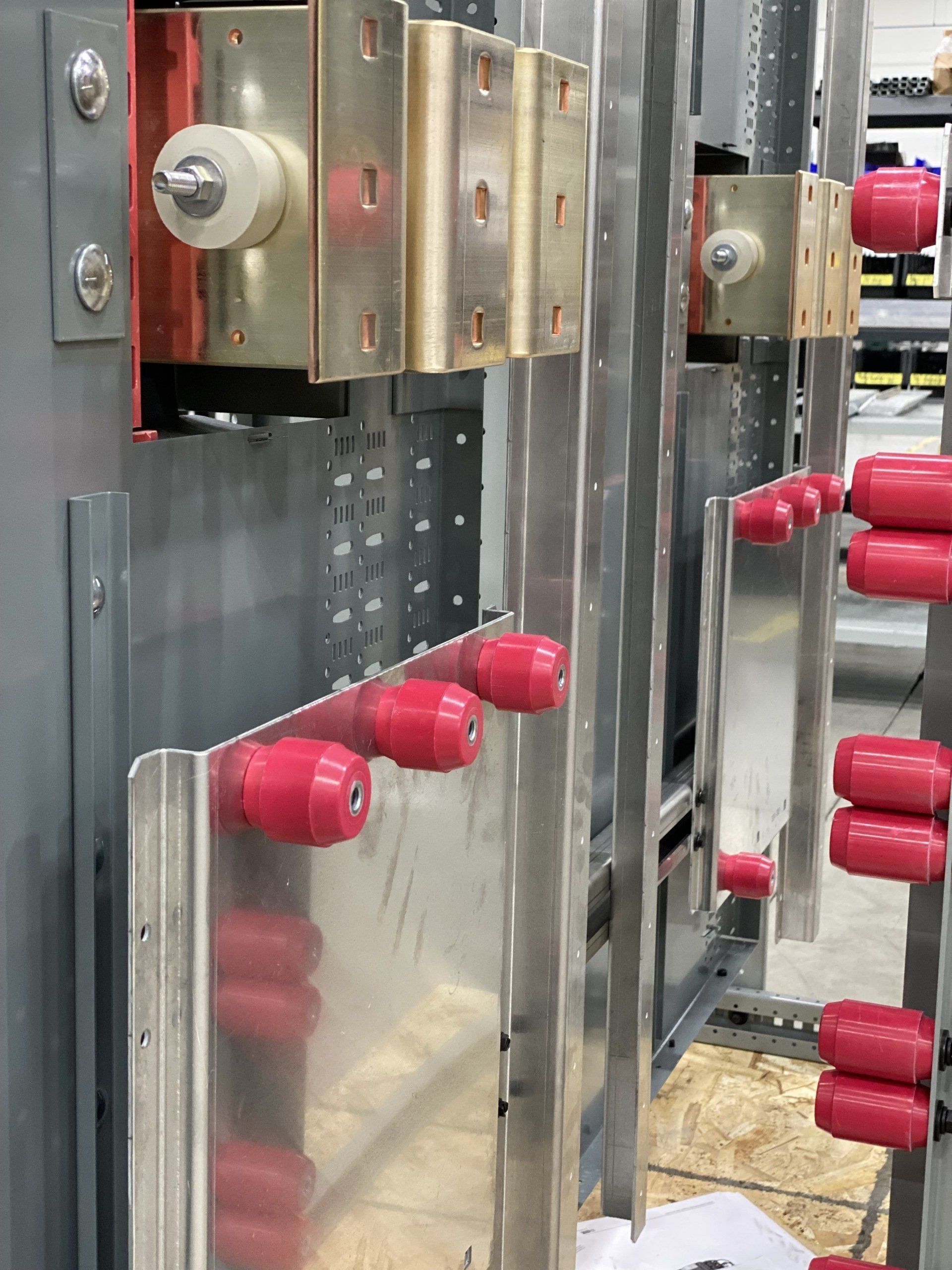 A bunch of red tubes are attached to a metal wall