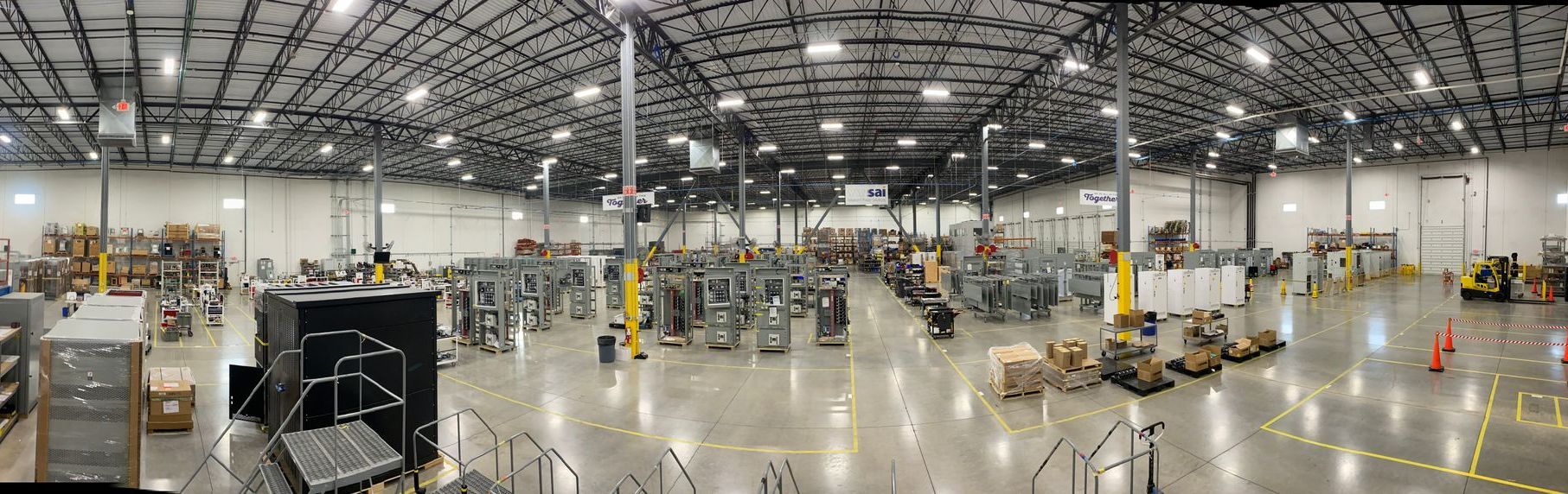 A large warehouse filled with lots of machinery and boxes.