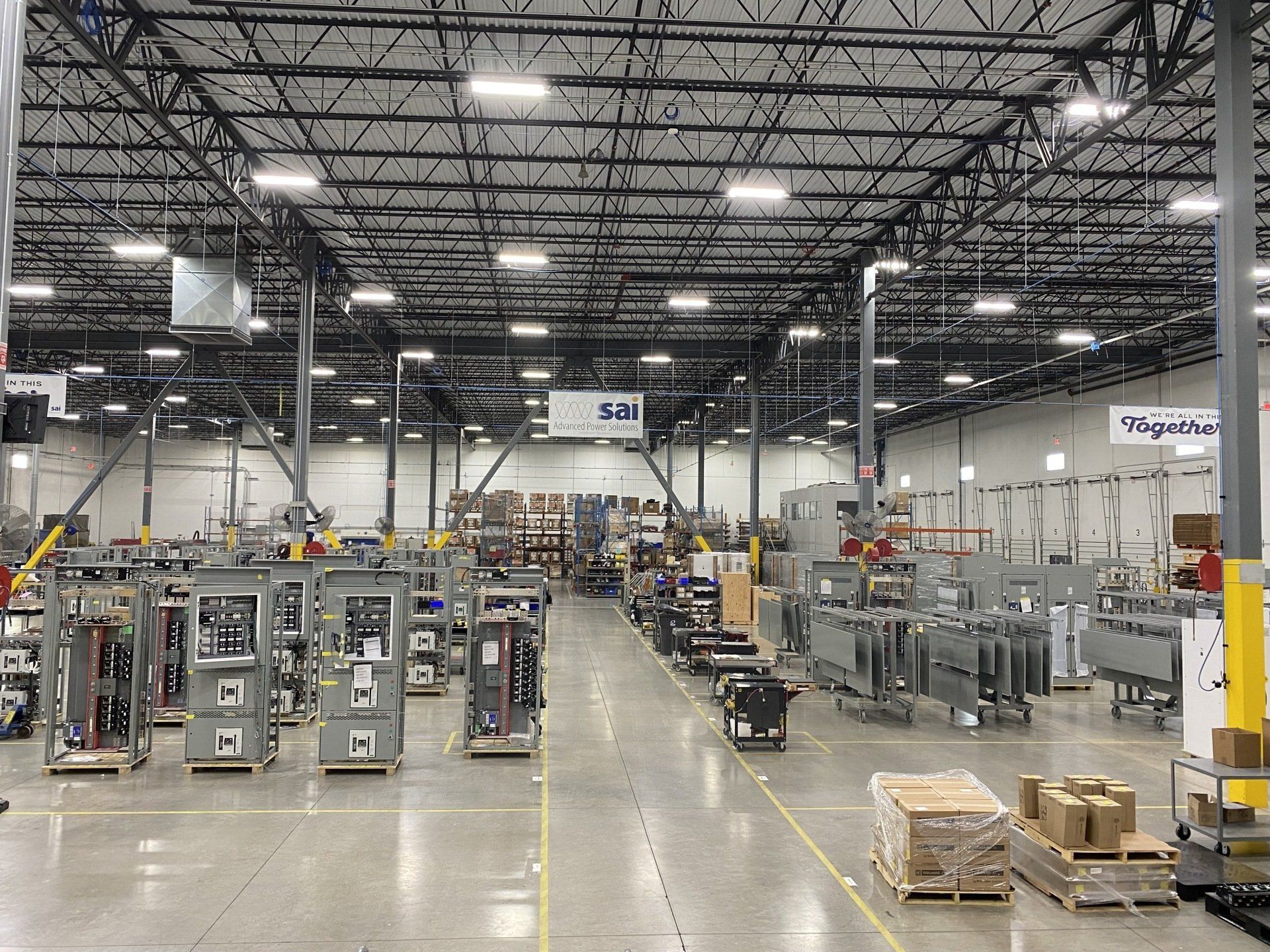 A large warehouse filled with lots of machinery and boxes.
