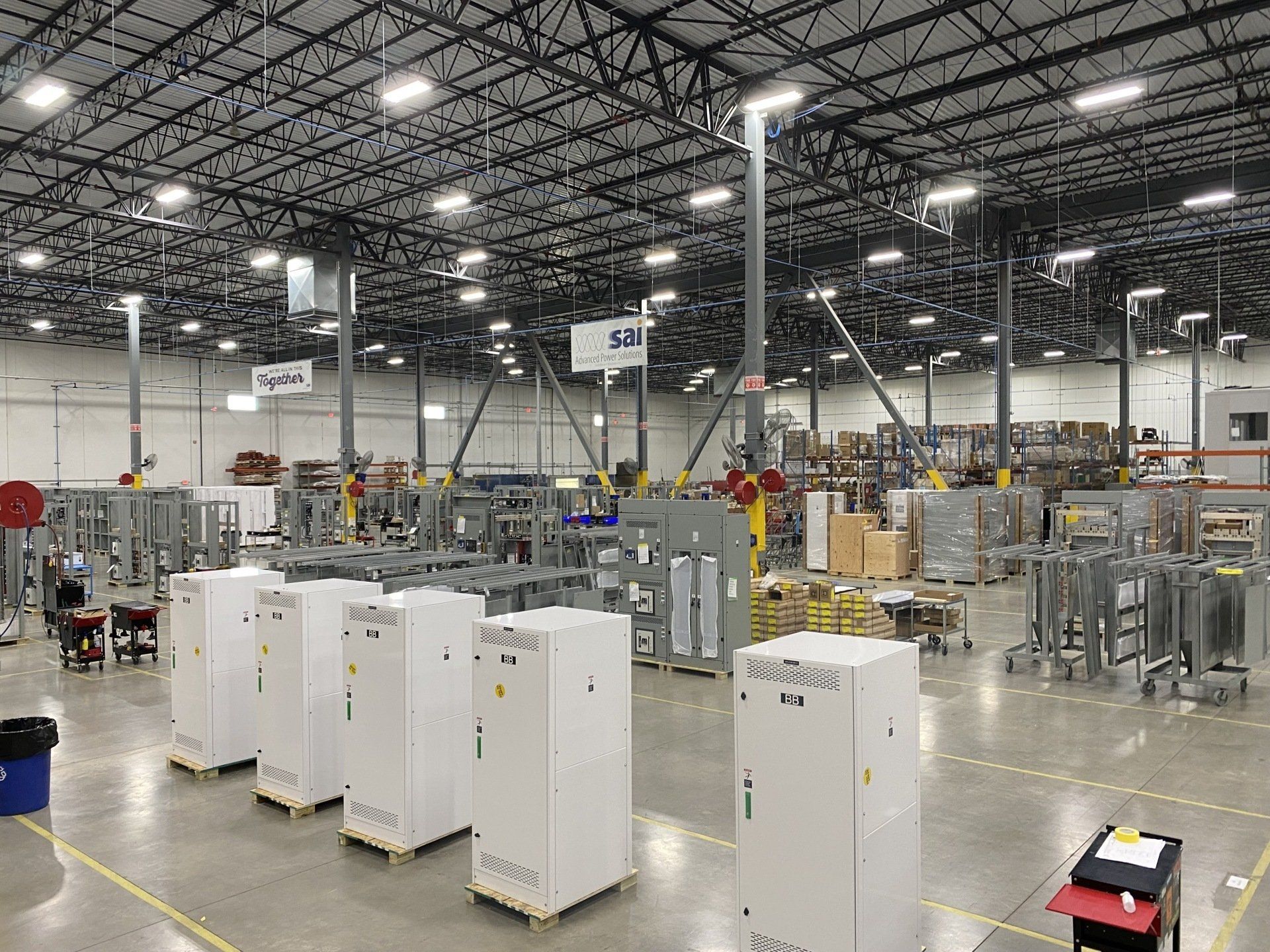 A large warehouse filled with lots of boxes and machinery.