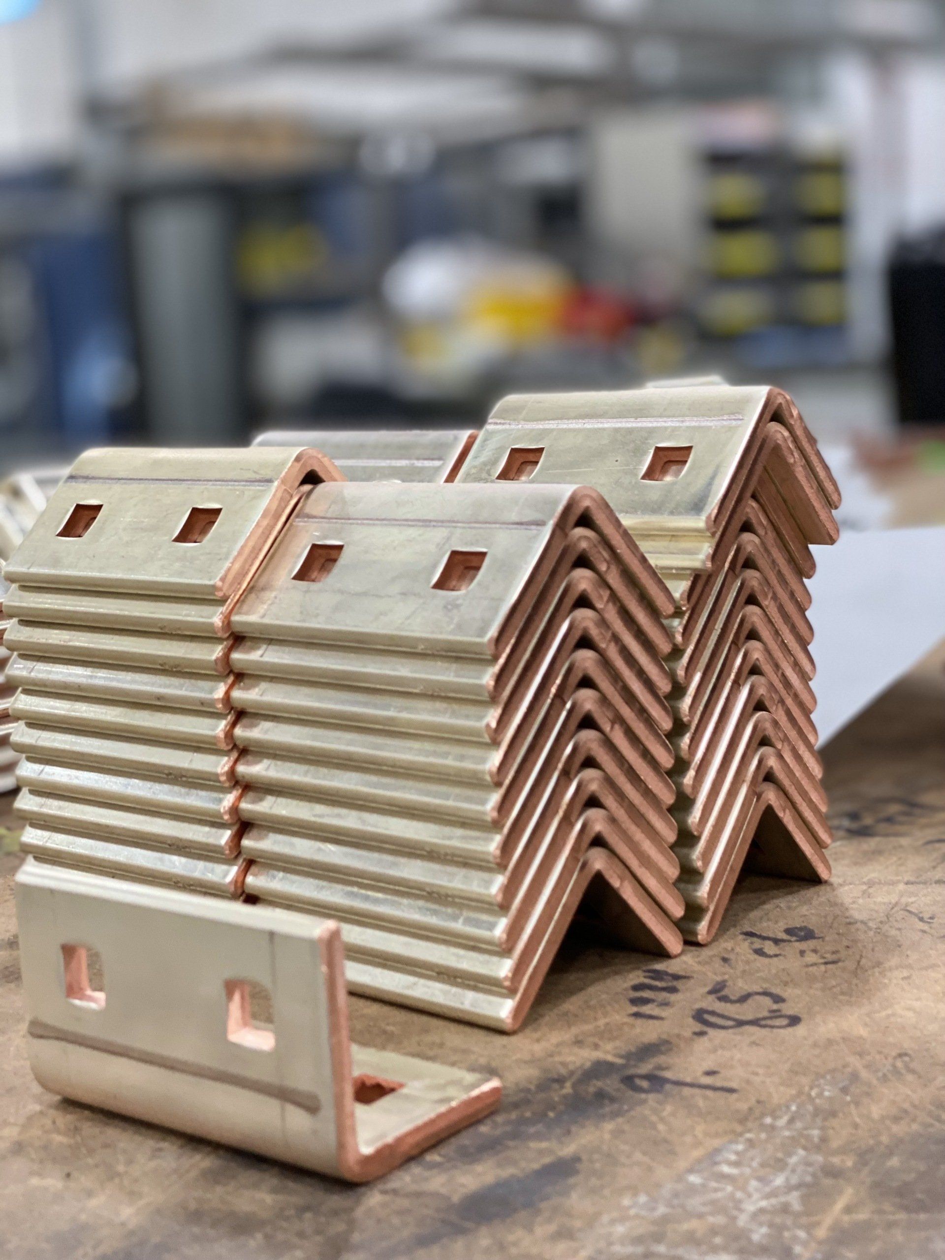 A stack of metal pieces sitting on top of a wooden table.