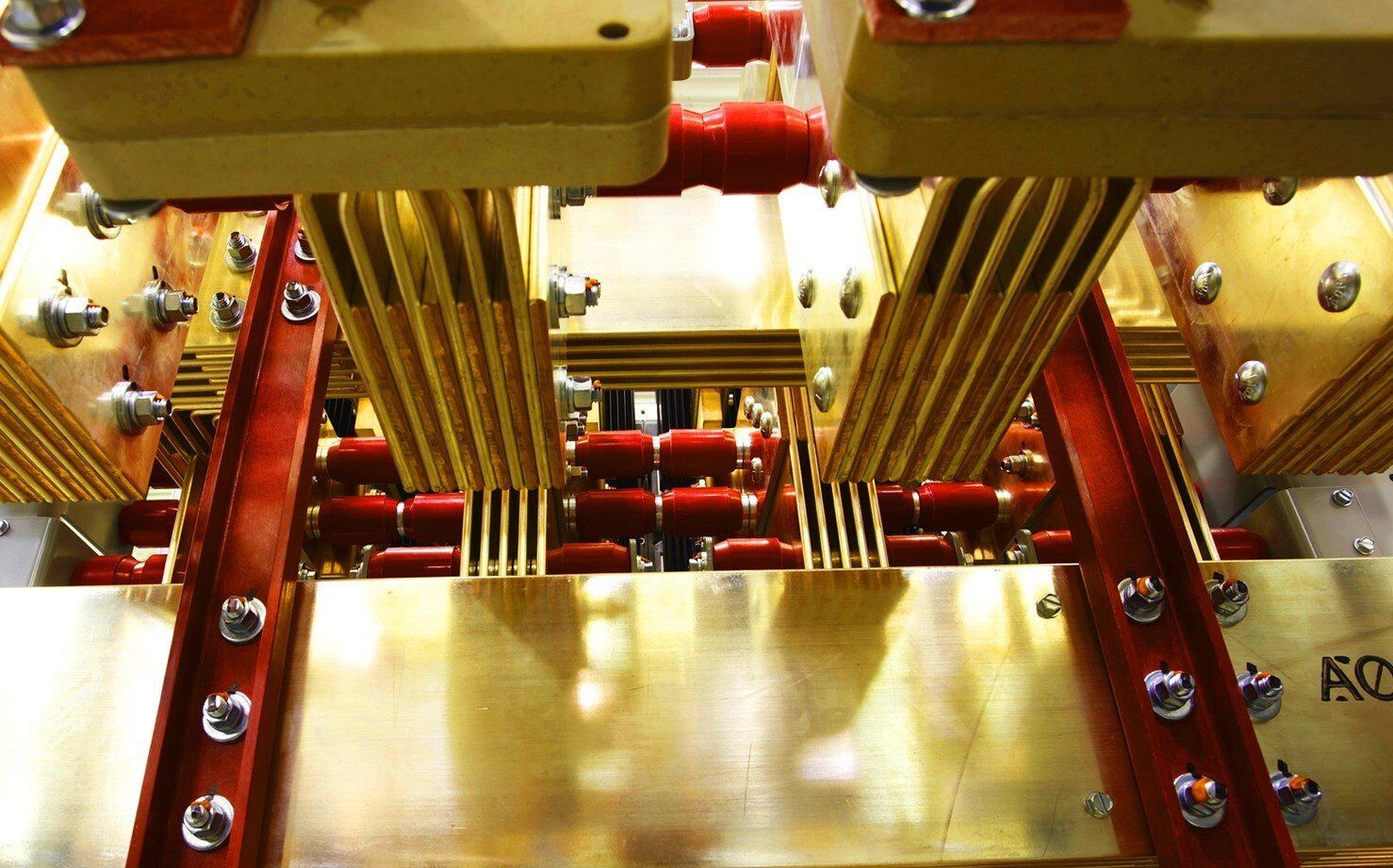 A close up of a machine with a lot of brass and red parts