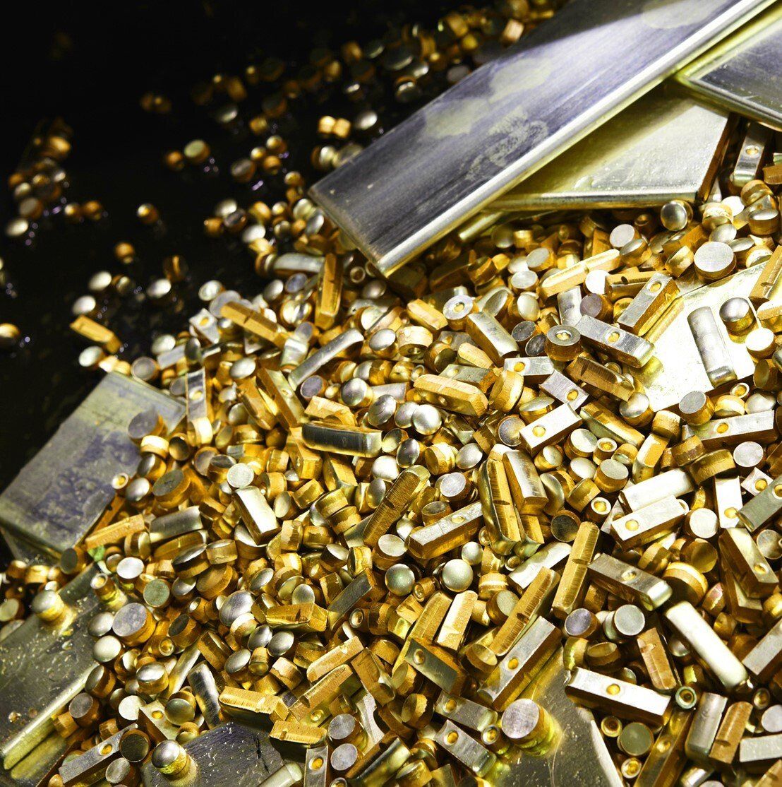 A pile of gold and silver metal pieces