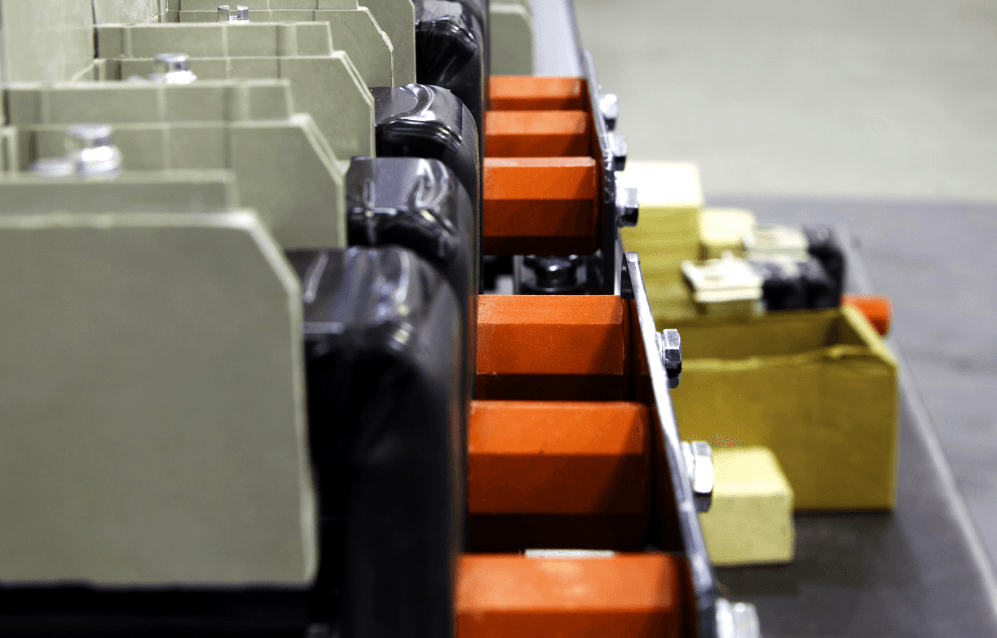 A conveyor belt filled with luggage in a warehouse.