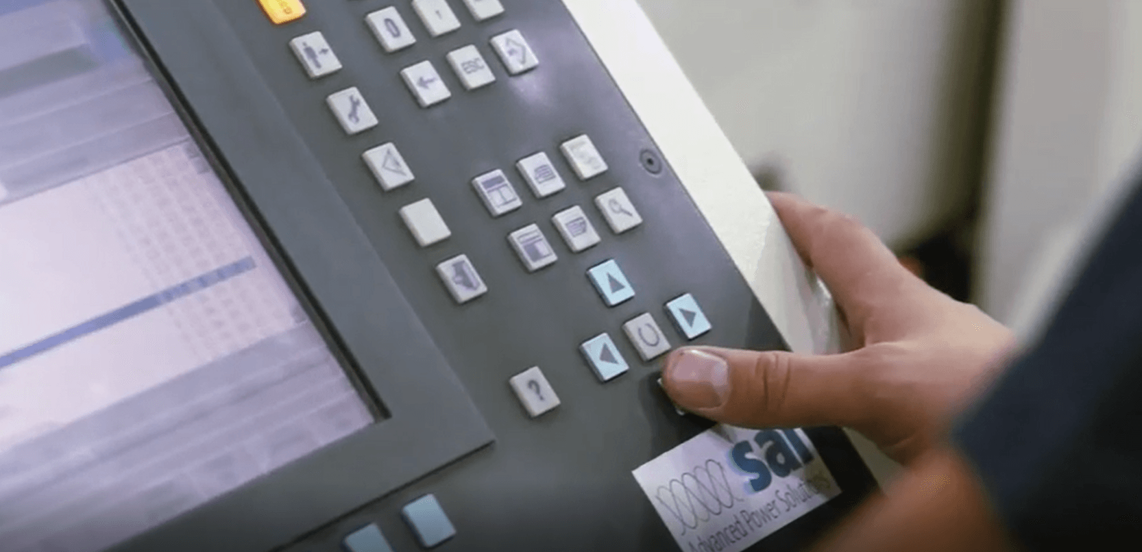 A person is pressing a button on a machine.