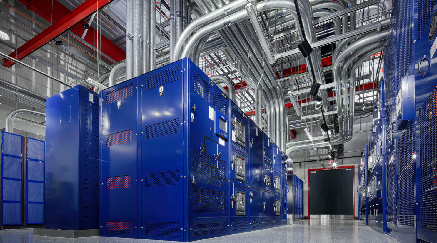 A large room filled with blue cabinets and pipes.