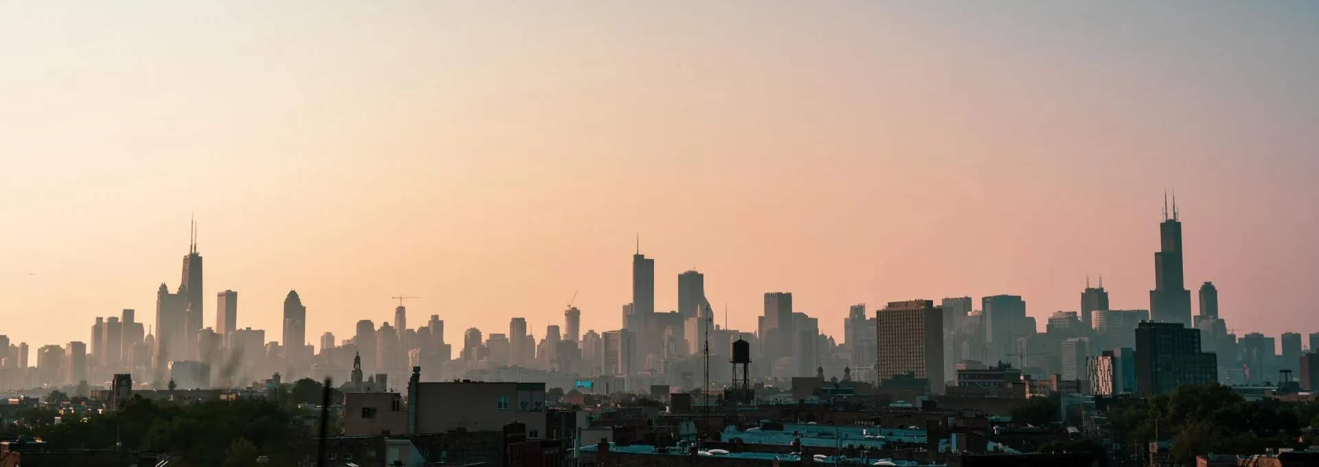 A silhouette of a city skyline at sunset.