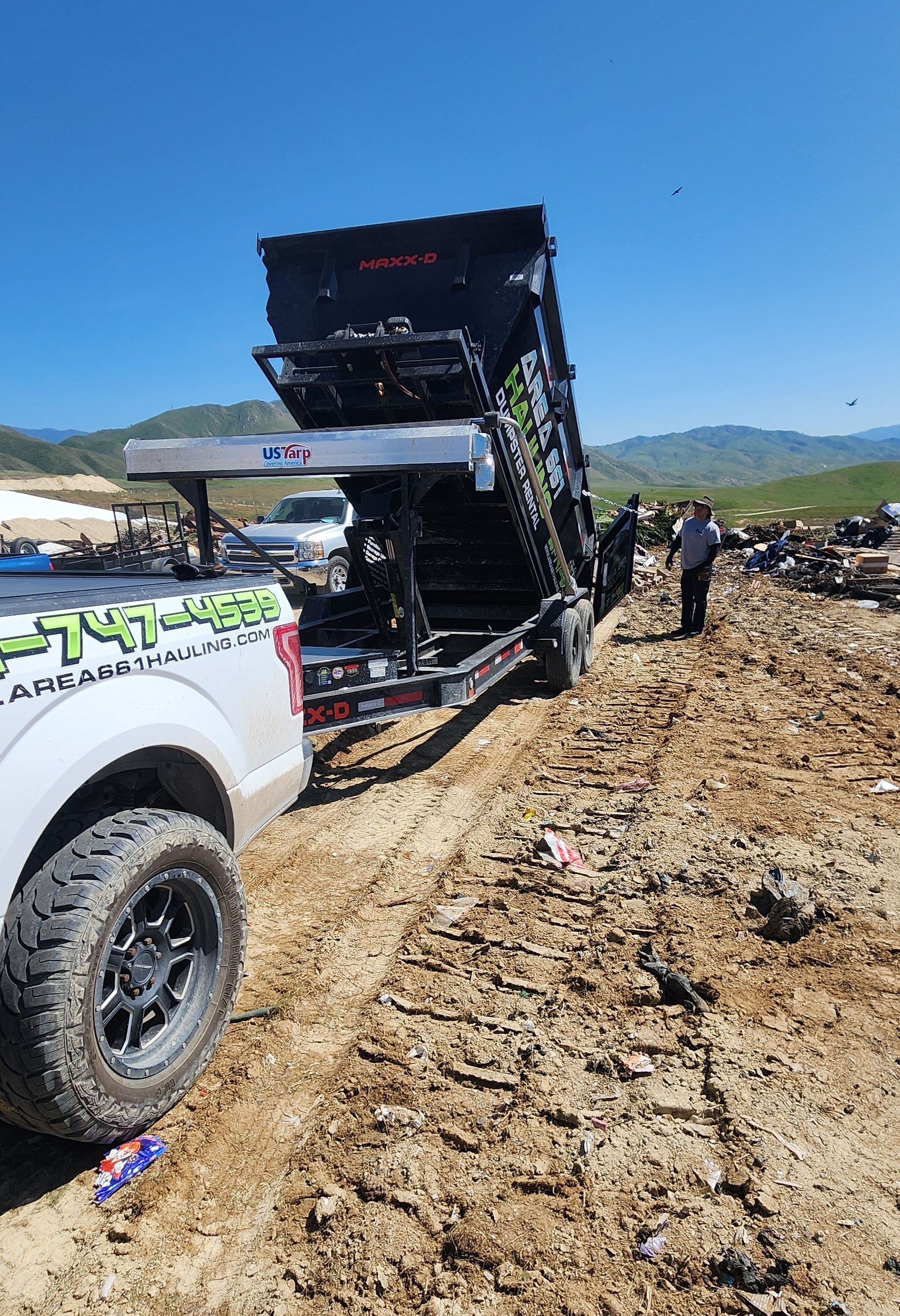 A truck is hauling off junk to the Bakersfield, CA dump