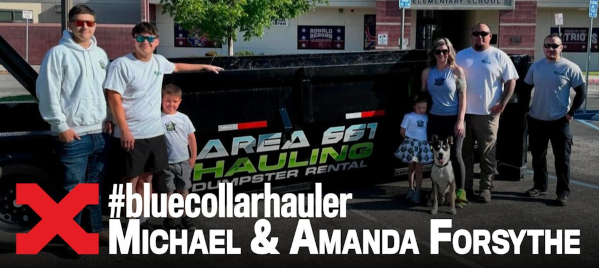 A group of people standing in front of a truck that says area 601 hauling in Bakersfield, CA