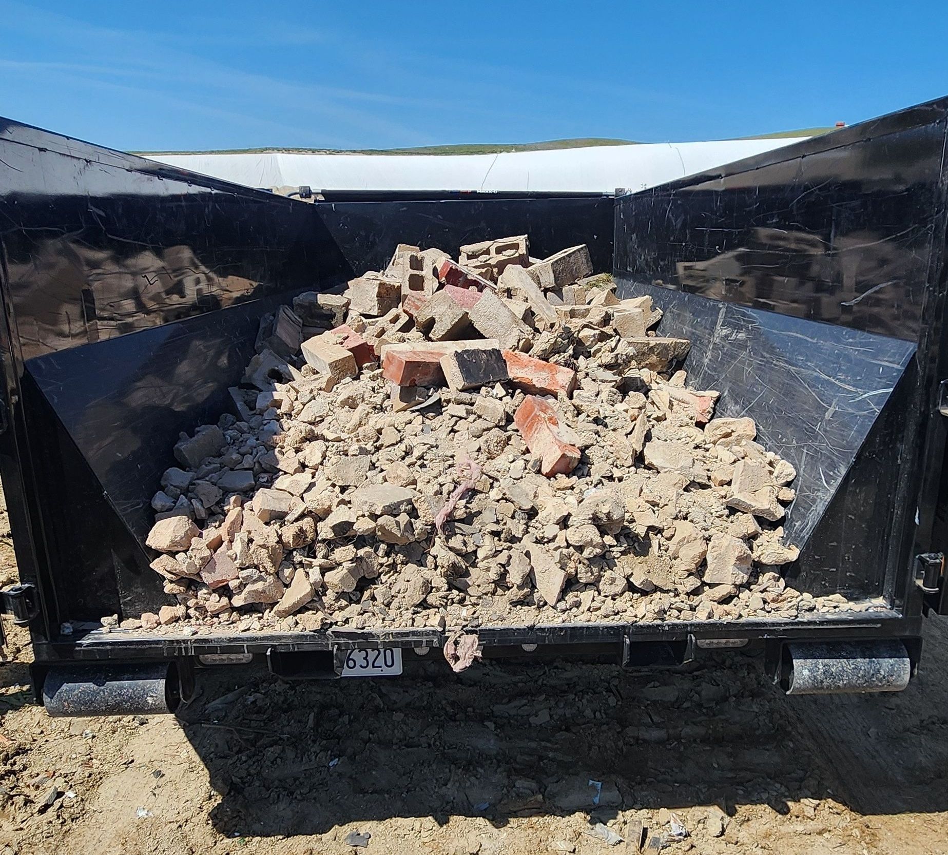 Filled with debris Dumpster Rental in Bakersfield.