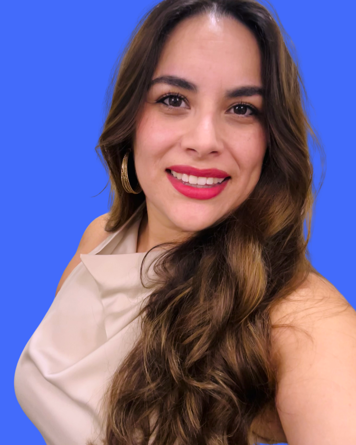 photo of a woman named Christina Lares with brown long hair red lipstick, gold hoop earrings, smiling in front of a blue background