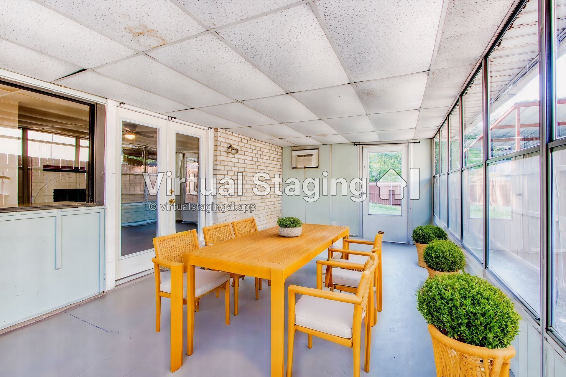 A screened in porch with a table and chairs