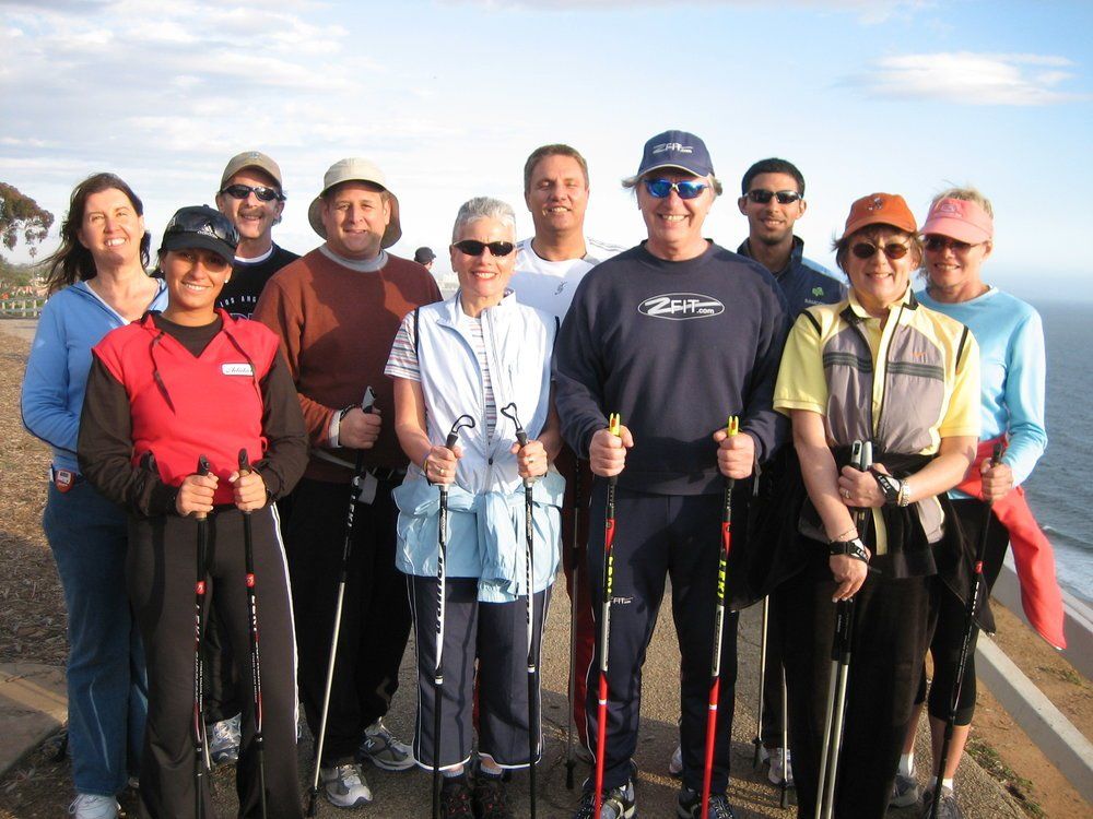 A group of people posing for a picture with walking poles