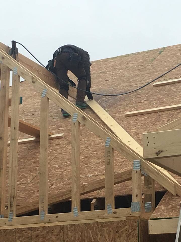 Worker finishing house wood frame — Construction Company in Bloomington, IN