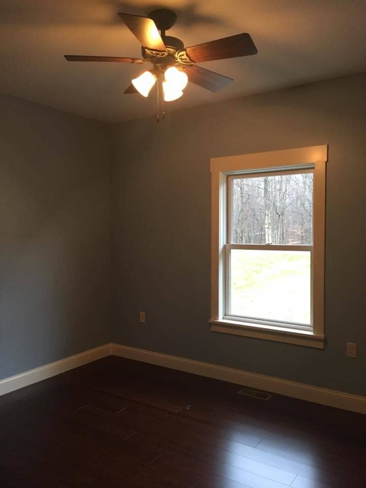 Empty room with new ceiling fan installed — Construction Company in Bloomington, IN