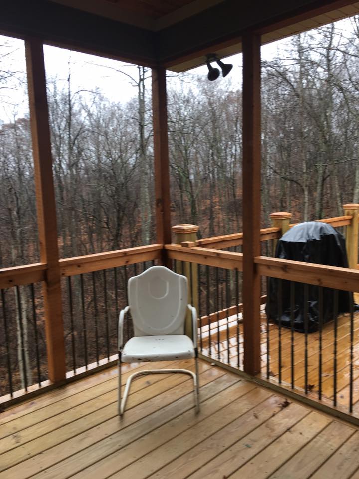 New wood deck with chair — Construction Company in Bloomington, IN