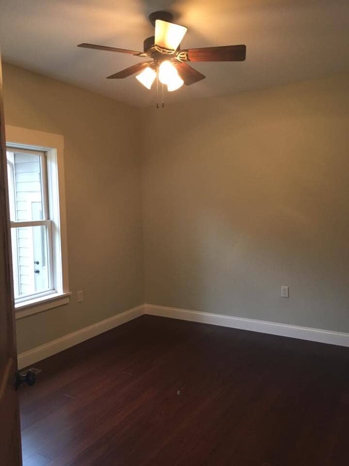 Empty room with new flooring — Construction Company in Bloomington, IN