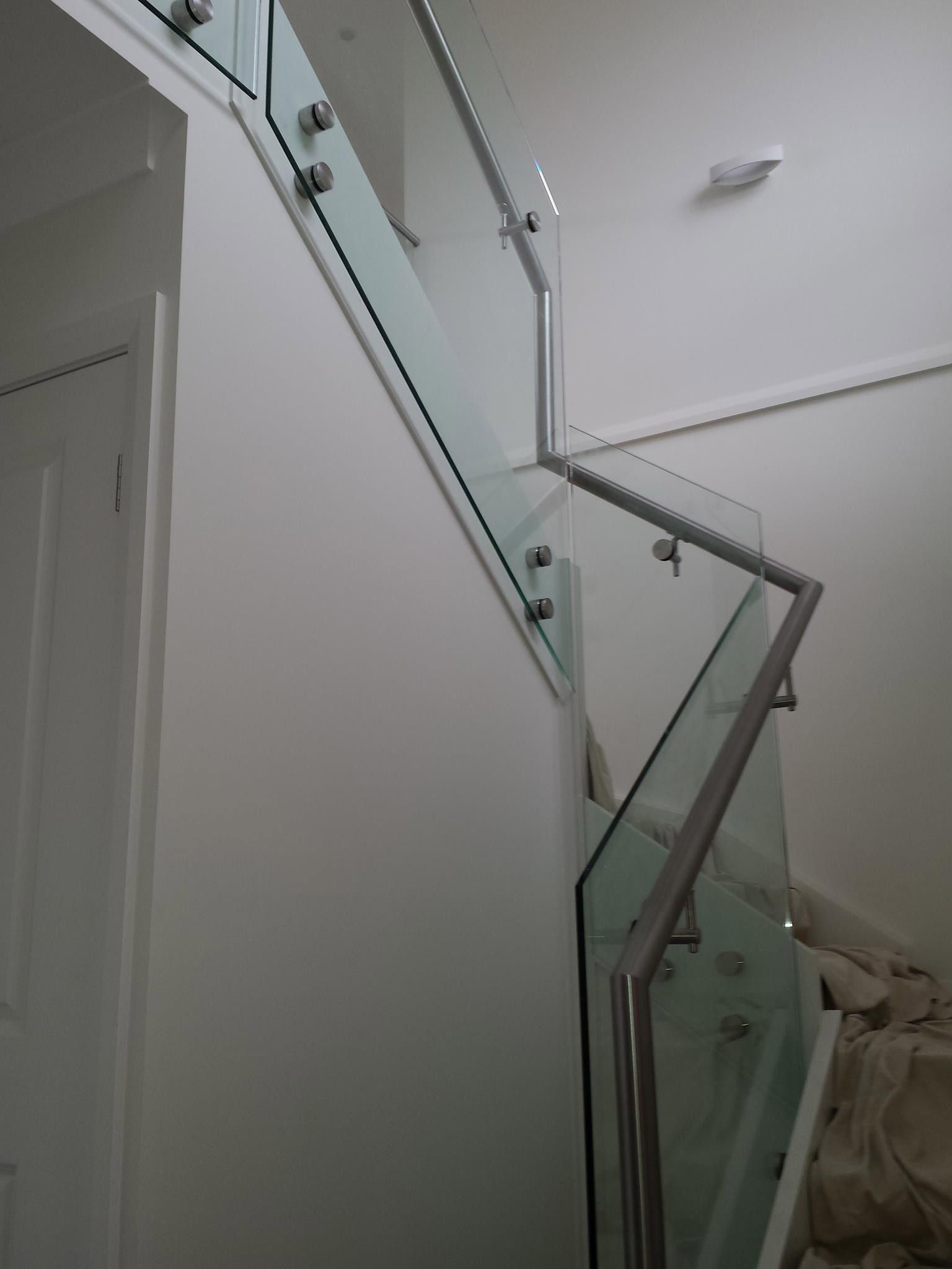 Minimalist staircase with a glass railing and a white wall — Balustrade in Kiama NSW
