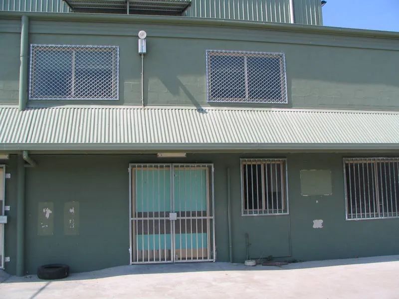 Green building with white bars on the windows — Balustrading in Unanderra NSW