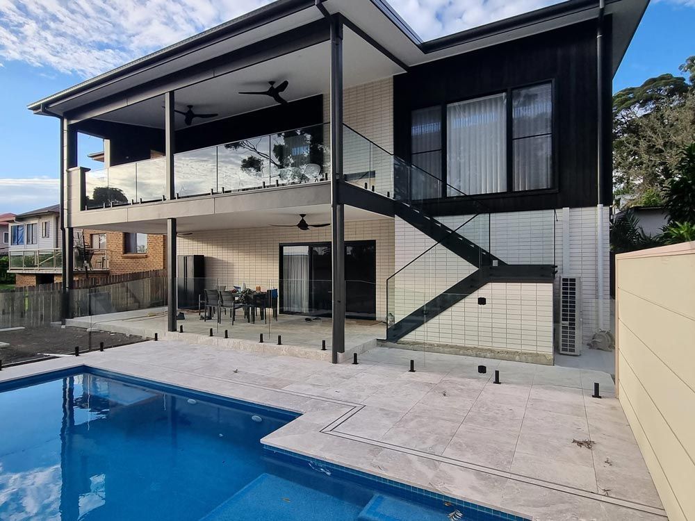 House with a large swimming pool — Pool Fence in Unanderra NSW