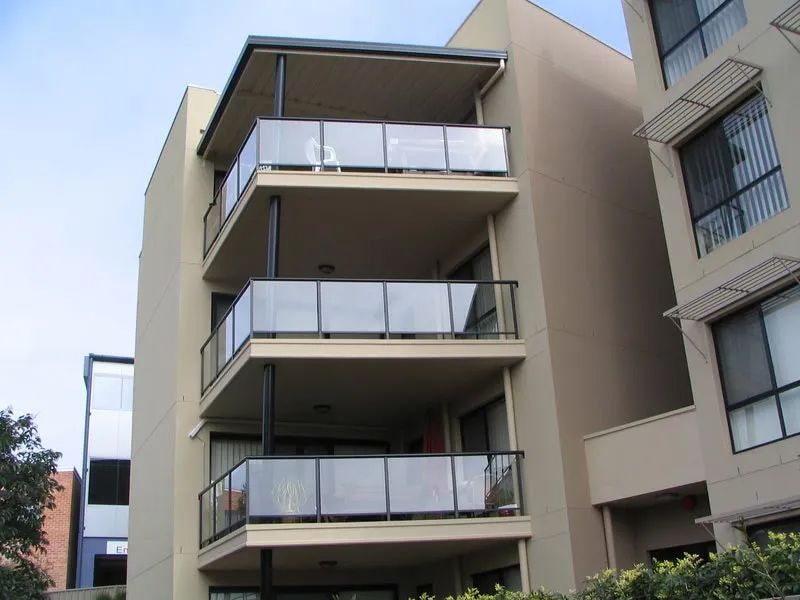 Commercial building with clear glass fence — Balustrading in Unanderra NSW