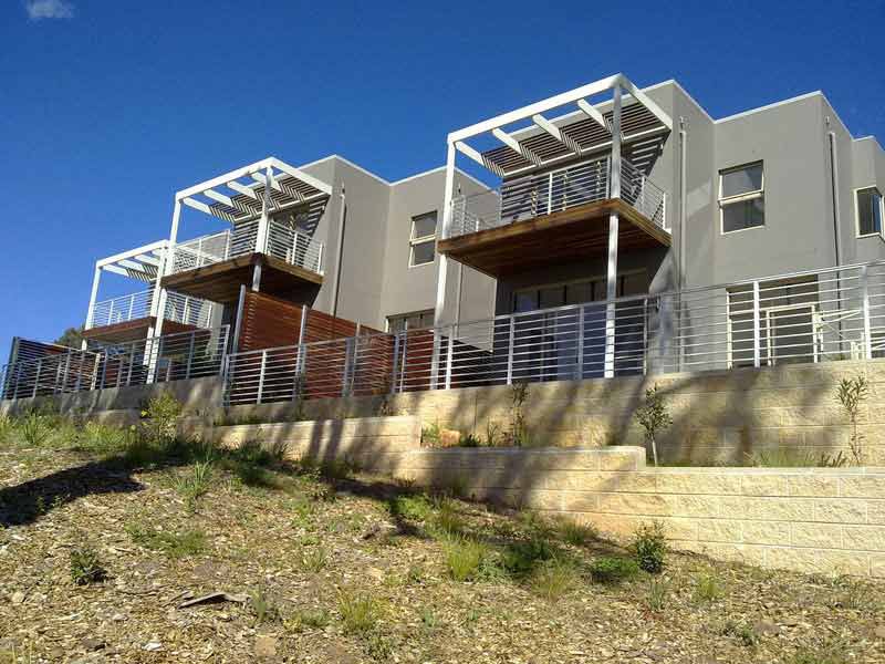 Row of houses on a hillside with balconies — Balustrading in Unanderra NSW