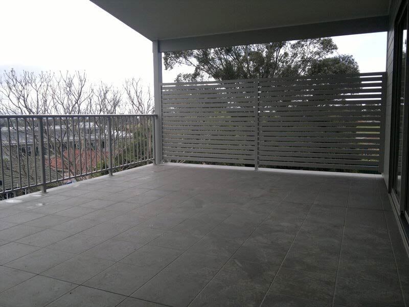An empty balcony with a fence and trees — Balustrading in Unanderra NSW